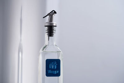 Close-up of glass bottle against white background