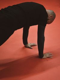 Low section of woman exercising on floor