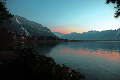 A lake in switzerland at dusk.