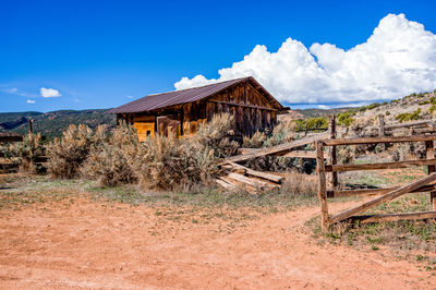 Built structure on landscape against sky