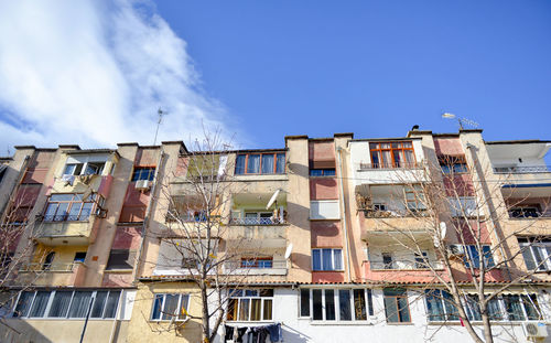 Low angle view of houses against blue sky