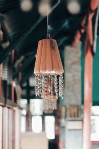 Close-up of lighting equipment hanging on roof of building