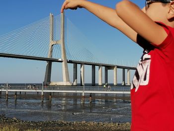 Low angle view of bridge over river against sky