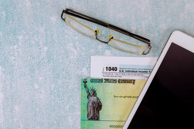 Close-up of text on paper on table against wall