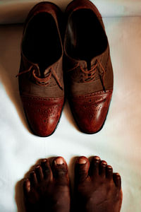 Low section of man wearing leather shoes
