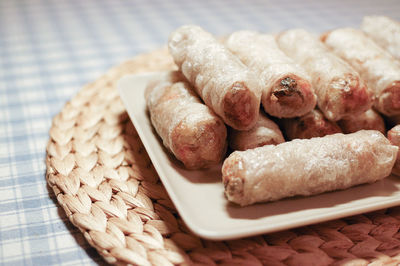 High angle view of spring rolls in plate on table