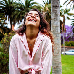 Portrait of smiling young woman looking away outdoors