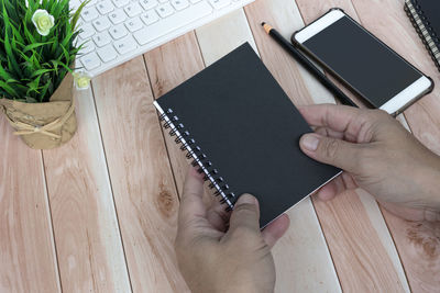 Cropped hands using digital tablet on table