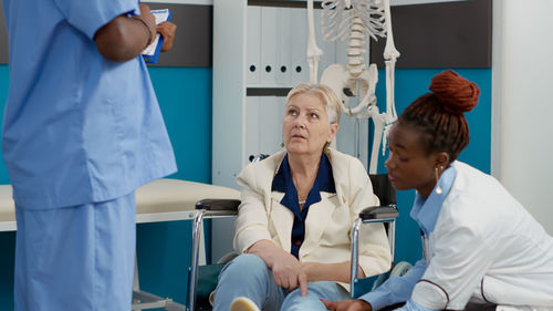 Female doctor examining patient in clinic