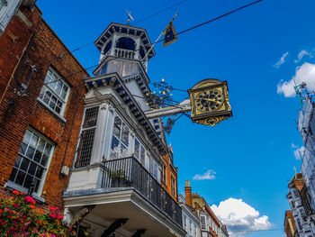 Low angle view of buildings against blue sky