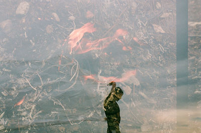 Digital composite image of people and woman standing on land