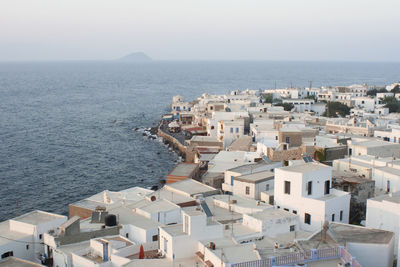 High angle view of town by sea against clear sky