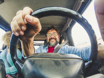 Portrait of man sitting in car