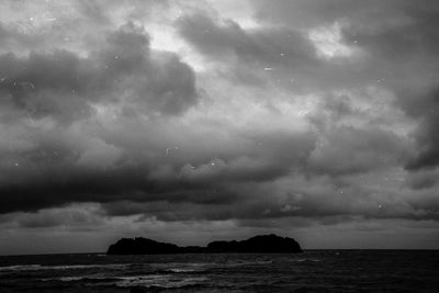 Scenic view of sea against cloudy sky