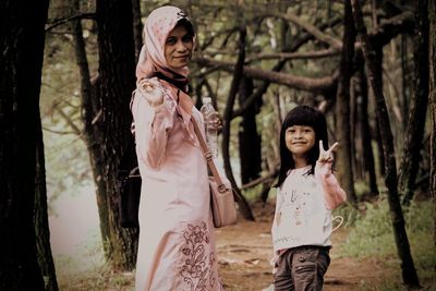 Portrait of mother and daughter in forest