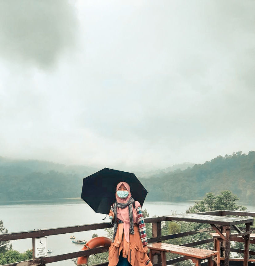 adult, nature, mountain, water, sky, cloud, fog, women, one person, clothing, copy space, umbrella, happiness, overcast, emotion, hat, architecture, day, railing, outdoors, young adult, travel, protection, environment, beauty in nature, standing, rain, vacation, smiling, travel destinations, landscape, sea, lifestyles, men, holiday, leisure activity, portrait, scenics - nature, trip, tranquility, holding, person