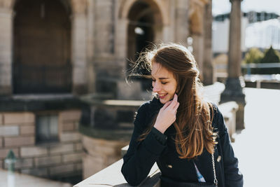 Young woman smiling outdoors