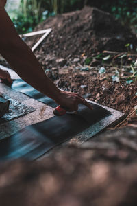 Worker working with tool in ground