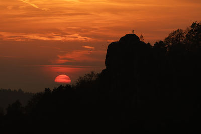 Silhouette temple against sky during sunset