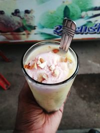 Close-up of hand holding ice cream