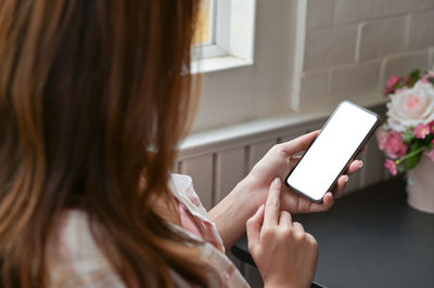 High angle view of woman using phone at home