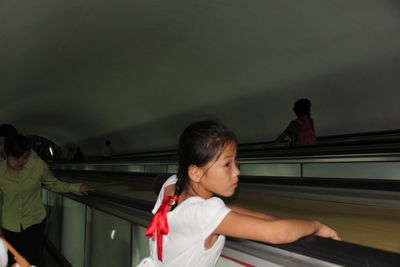 Rear view of friends standing on bus