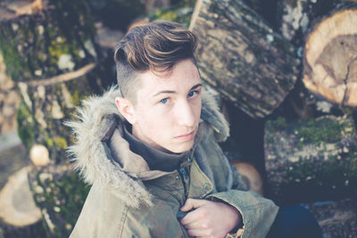 Close-up portrait of teenage boy standing in forest