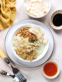 Bubur ayam or indonesian rice porridge with shredded chicken