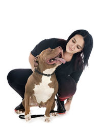 Woman with dog against white background