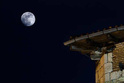 Low angle view of moon in sky at night