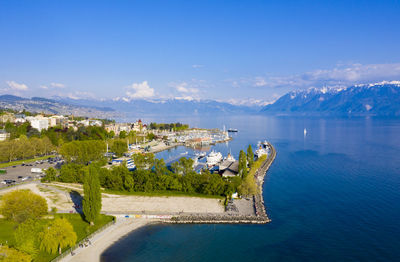 High angle view of townscape by sea against sky