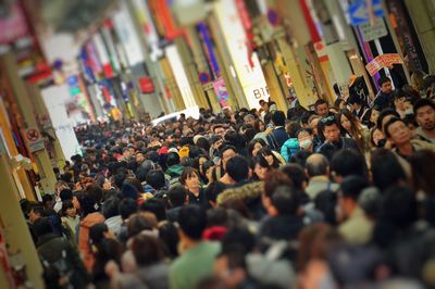 Crowd on alley in market at shinsaibashi