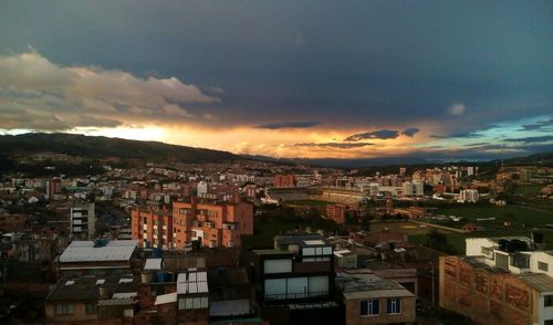 Cityscape against cloudy sky