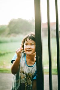 Portrait of smiling girl standing outdoors