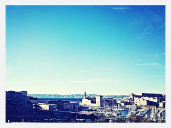 View of cityscape against blue sky