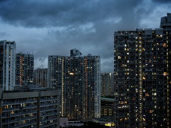 City skyline against cloudy sky