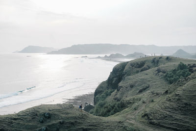 Scenic view of sea and mountains against sky
