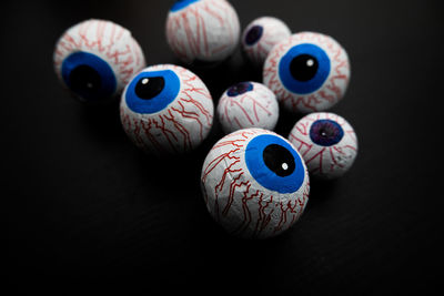 Funny halloween treat - candy eyeballs on dark background. copy space