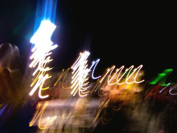 Low angle view of firework display at night