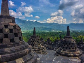 Ancient temple against cloudy sky