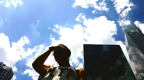 Low angle view of woman standing against sky