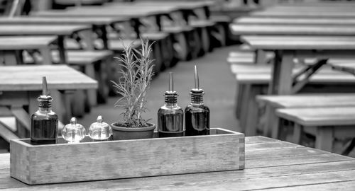 Close-up of bottles with potted plant in box on table