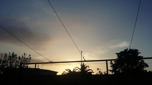 Low angle view of silhouette trees against sky during sunset