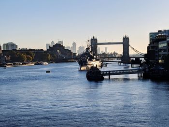 Boats in river with city in background