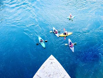 High angle view of people kayaking in sea