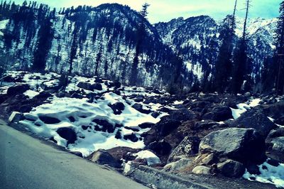 Scenic view of snow covered mountains against sky