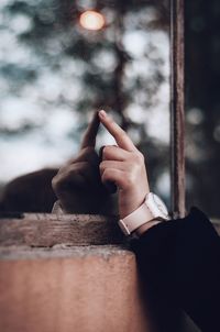 Midsection of person holding cigarette