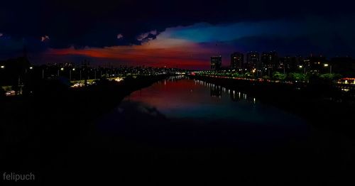 Illuminated cityscape against sky at night