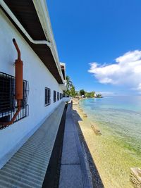 View of swimming pool by sea against sky
