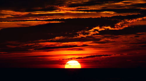Scenic view of sea against orange sky
